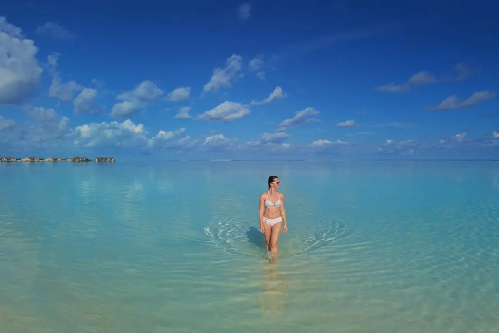 a woman in a garment standing in water