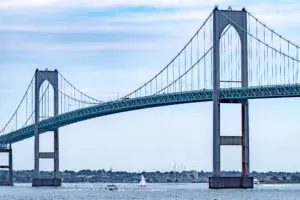 a bridge over water with boats in the background