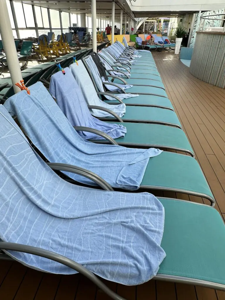 Lounge chairs with towels on them