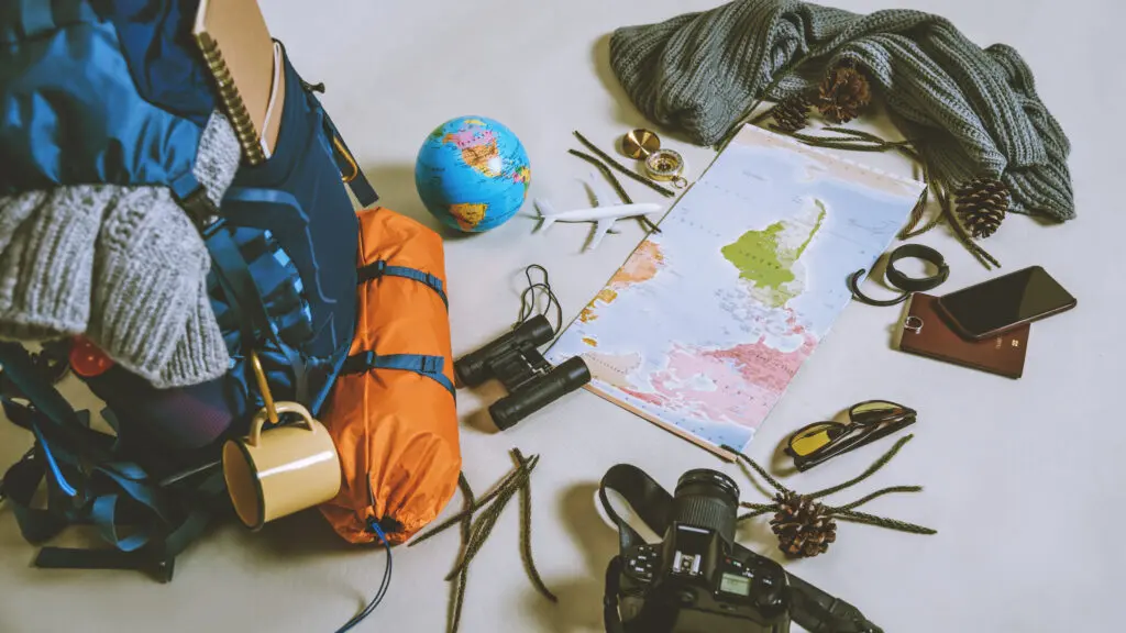 Travel accesssories laid out by a backpack