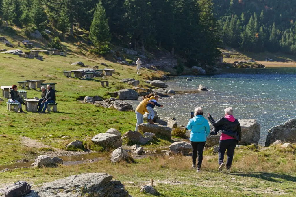 a group of people by a lake
