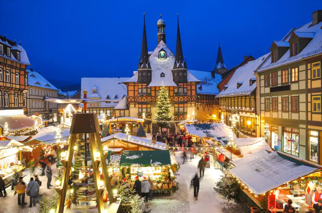 a large building with a christmas tree and people in it