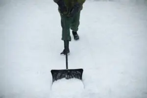 Top Winter Destinations person shoveling snow