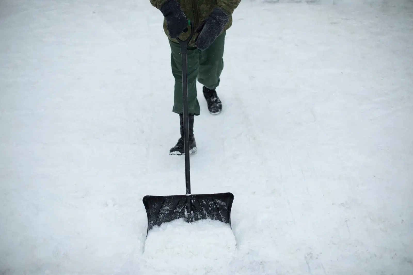 Top Winter Destinations person shoveling snow