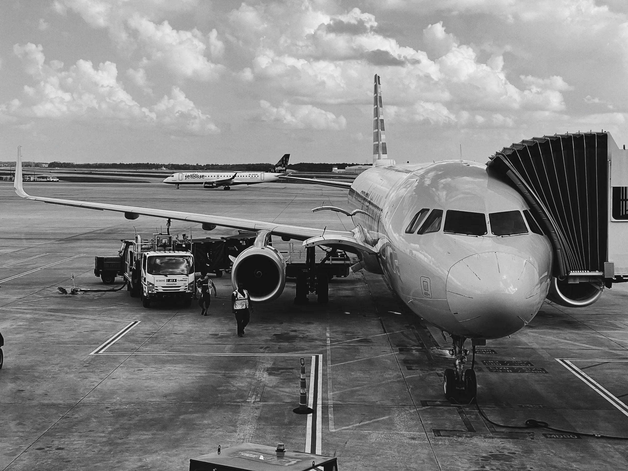 grayscale photo of airplane on airport. CLEAR membership, tsa precheck