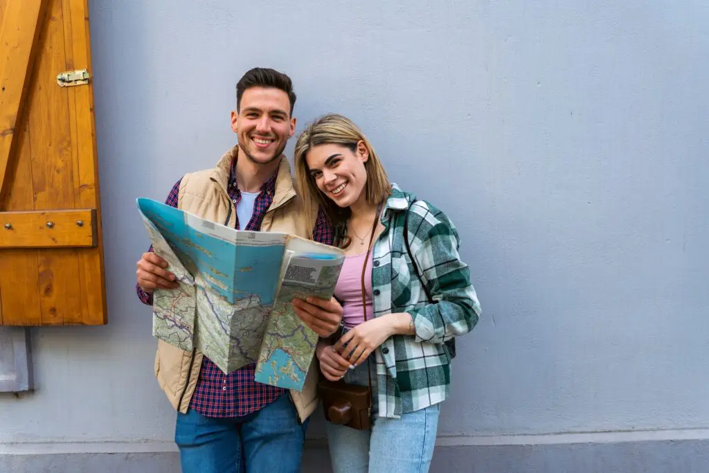 couple tourist in sightseeing in city using paper map