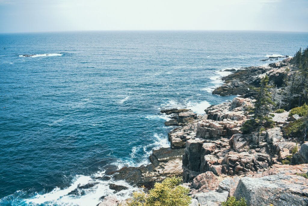 a rocky shore with a body of water